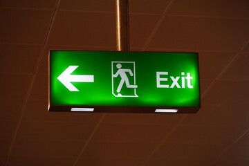 Running Man Sign Emergency Exit. Emergency Fire Exit With Floor. Emergency Exit Sign With Text in English In Modern Offices Inside An Industrial Plant. Interior Residential, Commercial Building.