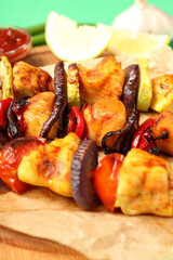 Concept of tasty food with chicken shashlik on green background