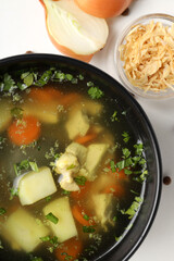 Concept of tasty food with chicken soup on white background