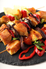 Concept of tasty food with chicken shashlik on white background