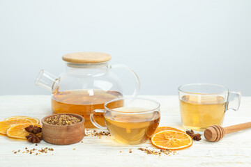 Concept of hot drink with buckwheat tea on white wooden table