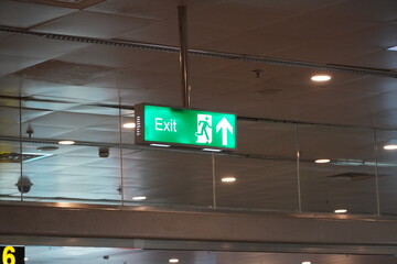 Running Man Sign Emergency Exit. Emergency Fire Exit With Floor. Emergency Exit Sign With Text in English In Modern Offices Inside An Industrial Plant. Interior Residential, Commercial Building.