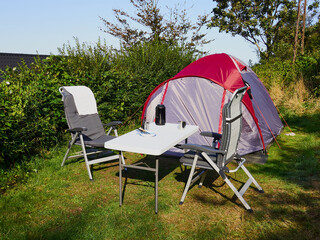 Red tent for primitive vacation in a simple camp camping ground