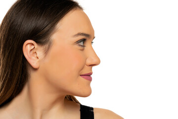 Fototapeta premium Profile of a young beautiful smiling woman with makeup