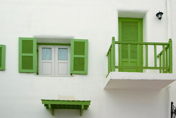 green window and door on the white wall