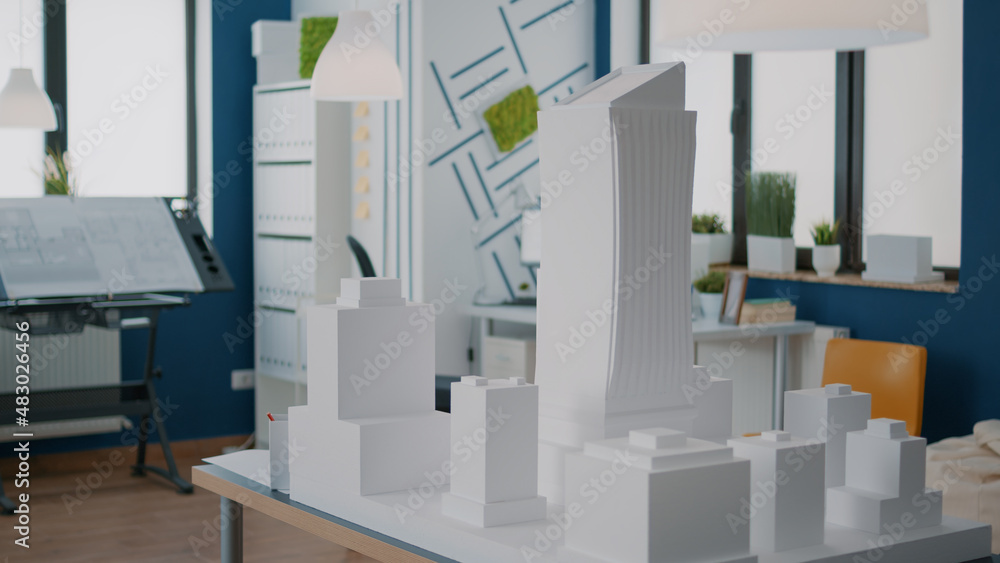 Poster table with building model and maquette presentation in empty architectural space. construction plan 