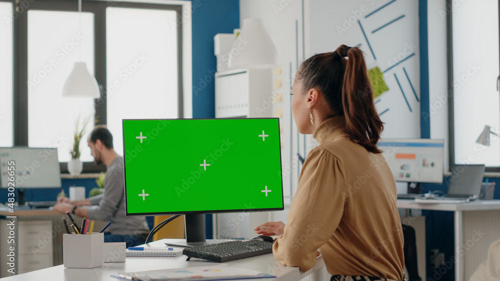 Poster company worker using computer with green screen in office. business woman working with mock up isola