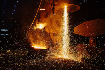 Pouring an ingot from a ladle. Ingot casting, casting foundry. Ladle-furnace. Iron smelting, Steel production. Electric steel furnace. Metallurgy. Industry steel production. 