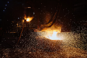 Pouring an ingot from a ladle. Ingot casting, casting foundry. Ladle-furnace. Iron smelting, Steel...