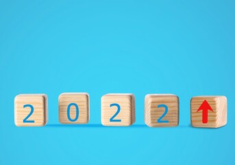 Wooden blocks with new year 2022, arrow up icons, Business development and growth concept