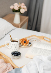 Fototapeta na wymiar Viennese waffles and coffee in bed.