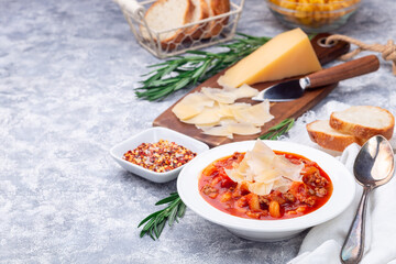 Minestrone soup with cavatappi pasta, beans and vegetables with crispy bread, horizontal, copy space