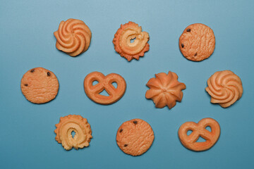 Variety danish butter cookies on blue background.