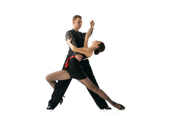 Beautiful sportive young man and woman dancing Argentine tango isolated on white studio background....