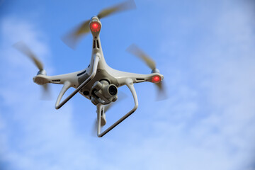 Naklejka na ściany i meble White drone with camera flying in summer mountain top