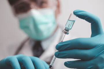 doctor or scientist in the COVID-19 medical vaccine research and development laboratory holds a...