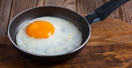 omelette in a pan on wooden background