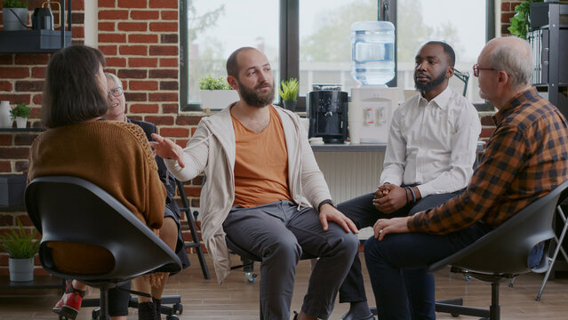 Man doing handshake with people applauding to celebrate therapy progress at aa meeting. Patients clapping hands after person shared achievement and addiction success. Rehab session