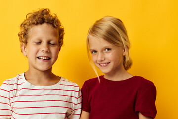 Small children cuddling fashion childhood entertainment on colored background