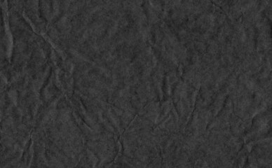 Closeup crumpled black paper texture background, texture. Black paper sheet with space for text ,pattern or abstract background.