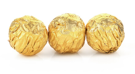 chocolate round balls in golden aluminum foil isolated on white background