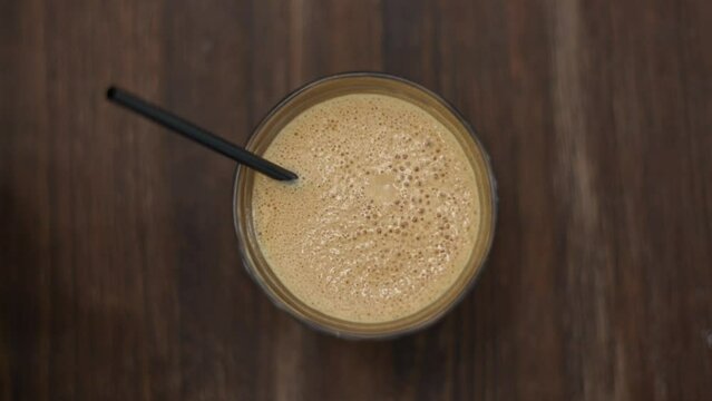 Sped-up shot of frappe bubbles popping in the froth. Traditional Greek iced coffee.