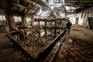 man on abandoned and ruined factory