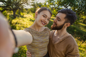 portrait of a couple taking a selfie in nature