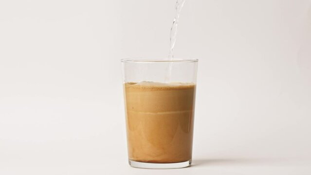 Preparation of Greek frappe, iced instant coffee on white background.