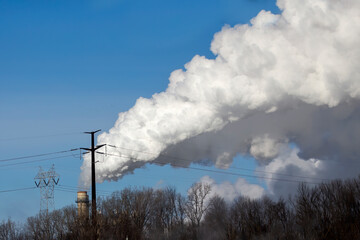 Thick smoke rising from the chimney of a power plant