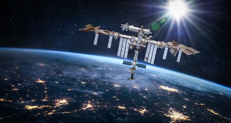 International space station in 2022 in outer space with Earth at night. ISS floating on orbit of...