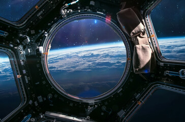 Earth planet in ISS porthole. View from Cupola. International space station. Orbit and atmosphere....