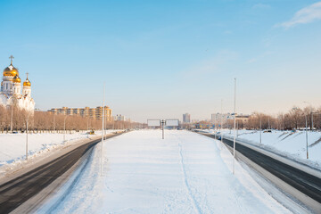 Fototapeta premium Panorama of wide streets in the city of Togliatti in winter with a view of the church and empty billboards. Togliatti, Russia - 4 Jan 2022