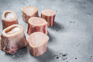Raw calf Marrow bones on butcher table. Gray background. Top view. Copy space