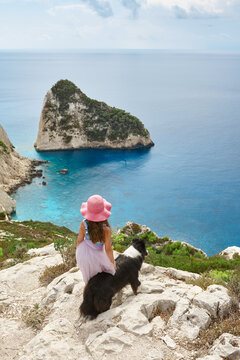 Little girl and dog watching beautiful sea landscape