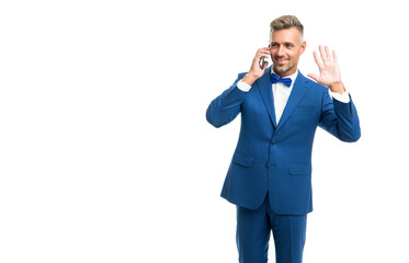 happy man in blue bow tie suit talk on phone isolated on white with copy space. hello