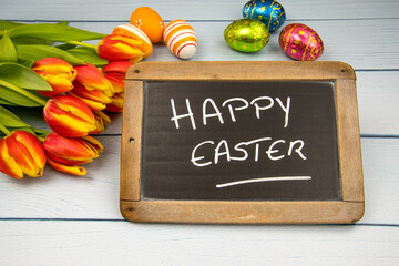 slate with happy easter written on it 