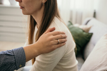 a gesture of support. a woman's hand on the shoulder of a distressed female patient. psychological...
