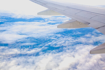 Morning sunrise with Wing of an airplane flying above the ocean. The view from an airplane window. Photo applied to tourism operators. picture for add text message or frame website.