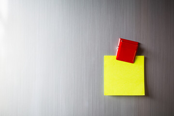 Empty paper sheet on refrigerator door with magnetic clip paper note for add text message.