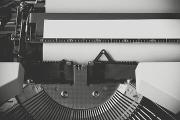 vintage picture. Close up typewriter with white paper sheet. Space for your text message.