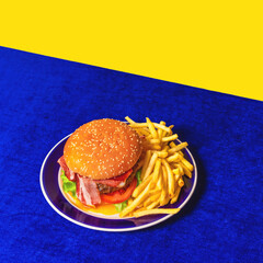 Food pop art photography. Delicious burger, hamburger, french fries on bright blue tablecloth isolated on yellow background. Vintage, retro style