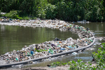 Floating litter boom from the Litter Boom Project used to collect plastic litter in the Black River, Cape Town. © Fearless on 4 Wheels
