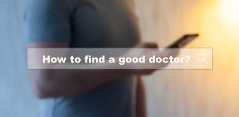 A young man searches the Internet on a smartphone for information - How to find a good doctor