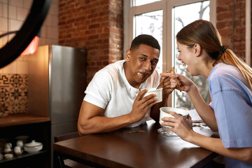 Girl point with finger on guy face in sauce