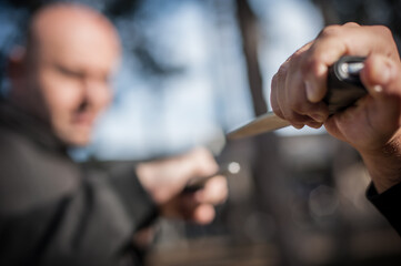 Knife vs knife fight. Kapap instructors demonstrates sombrada drill training