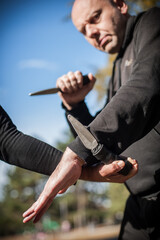Knife vs knife fight. Kapap instructors demonstrates sombrada drill training
