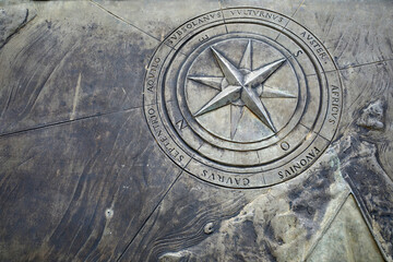 Fototapeta na wymiar Compass rose on an ancient stone