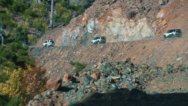 cars leave from behind the mountain and rush along the serpentine. Beautiful mountain landscape