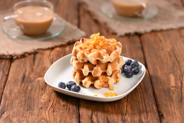 Appetizing waffles with jam for dessert.